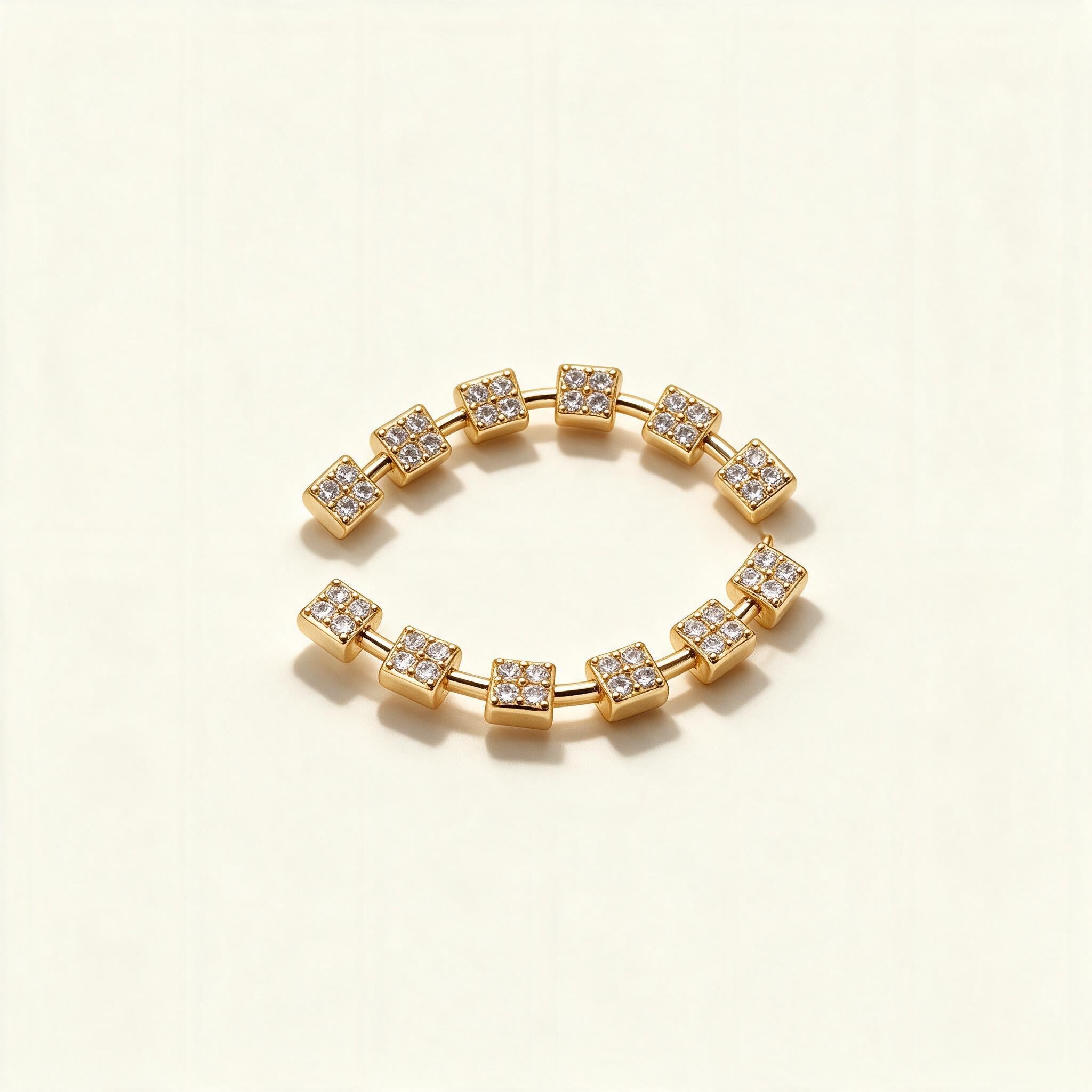 Pair of curved gold-tone ear climber earrings with pave cubic zirconia square stations