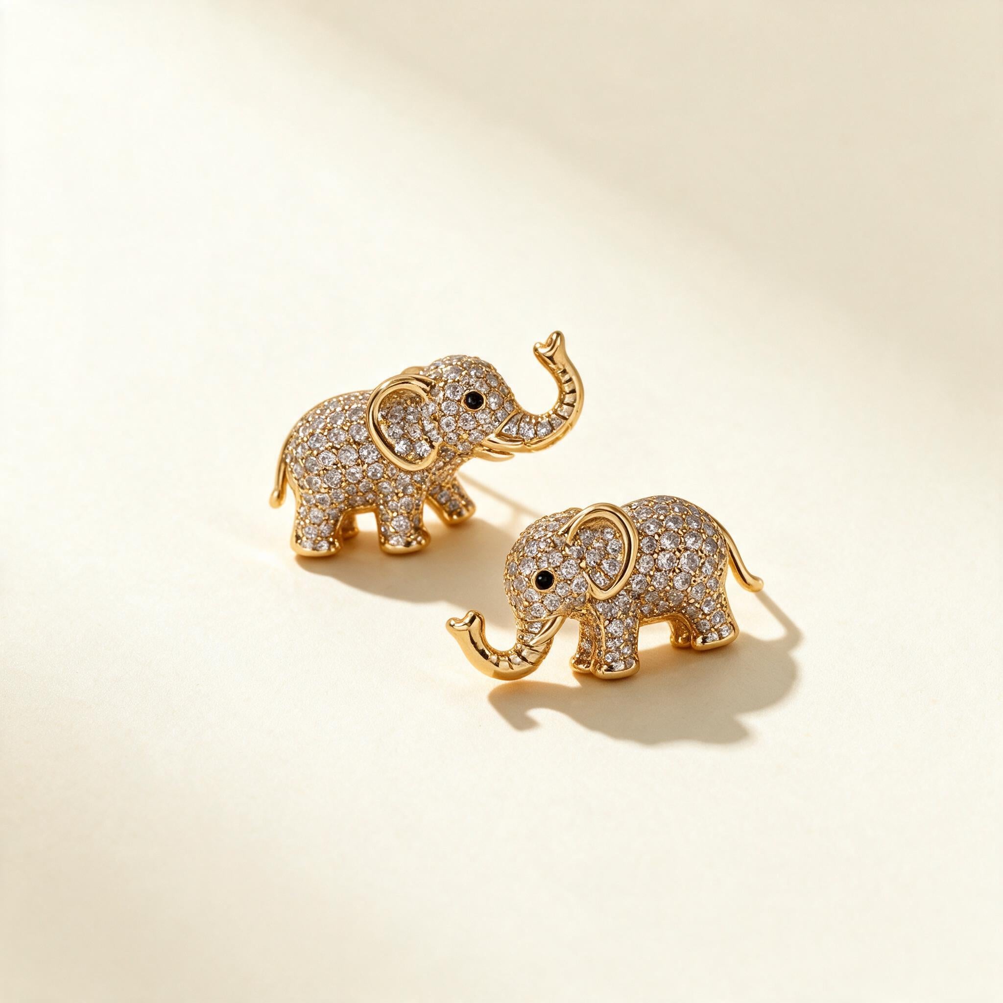 Pair of gold-tone elephant stud earrings set with pave cubic zirconia and raised trunks