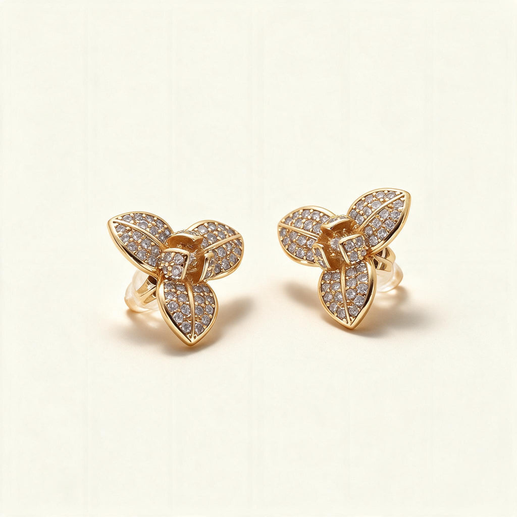 Gold-tone three-petal flower stud earrings with pave cubic zirconia on each petal