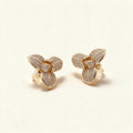 Gold-tone three-petal flower stud earrings with pave cubic zirconia on each petal