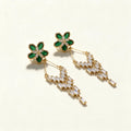 Gold-tone drop earrings with a green stone flower top and a staggered fringe of baguette crystals