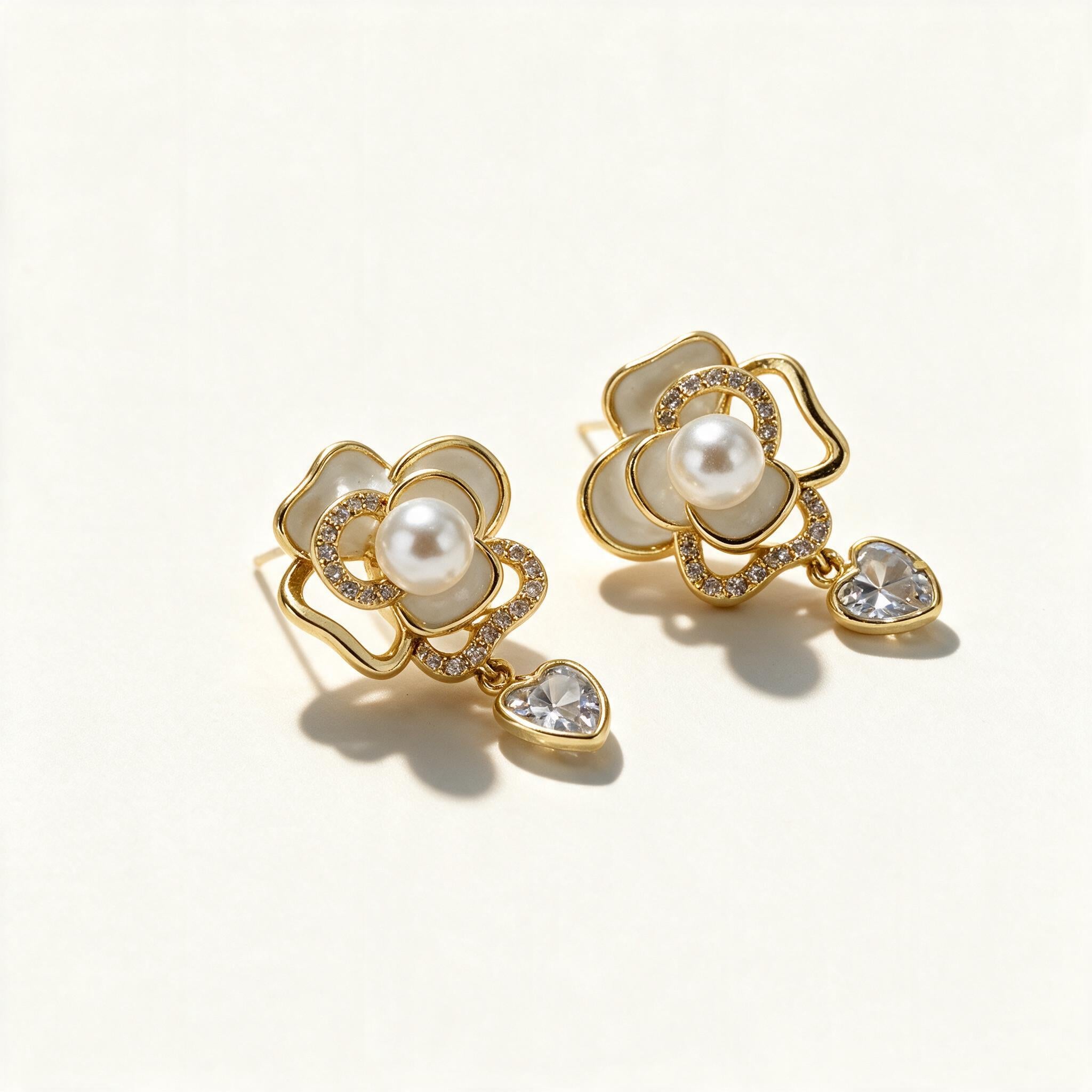 Gold-tone white enamel rose earrings with pearl centre and heart-cut crystal drop