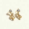 Gold-tone drop earrings with heart-cut cubic zirconia studs and pave crystal bow charms