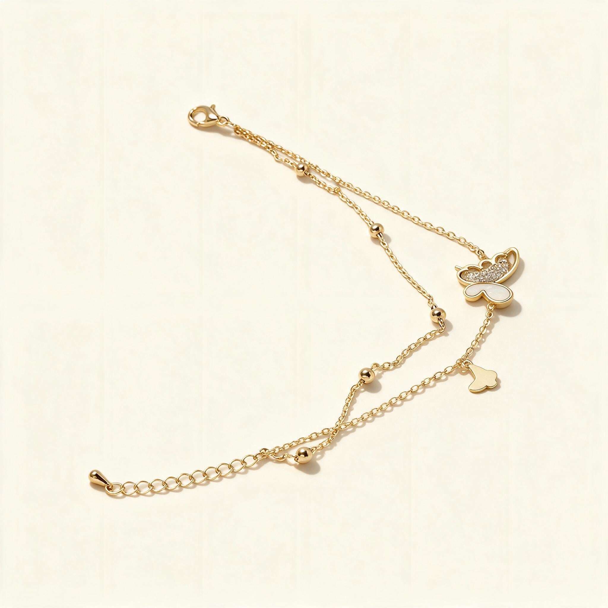 Gold-tone layered double chain necklace with mother-of-pearl butterfly pendant