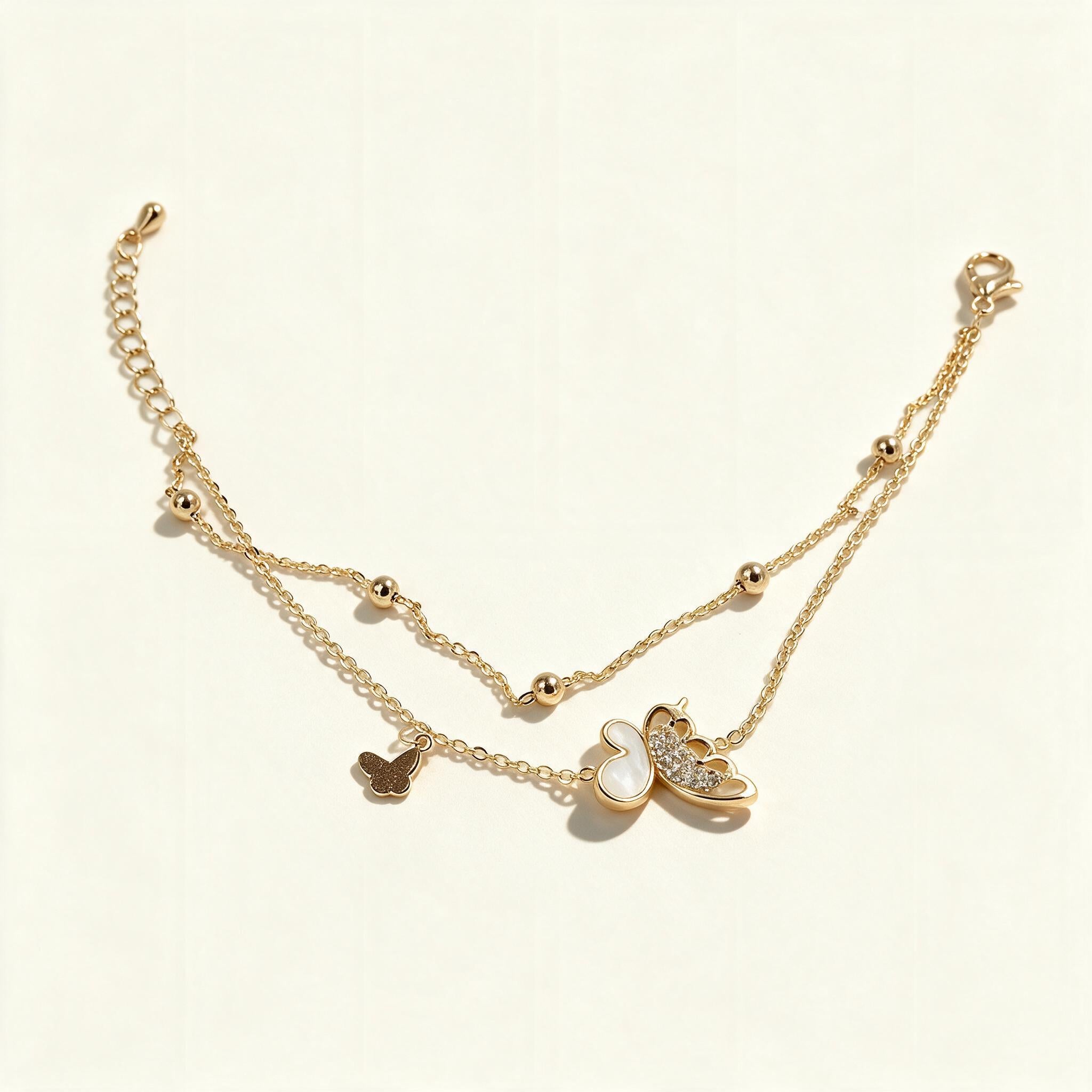 Gold-tone double layer necklace with mother-of-pearl and gold butterfly charms