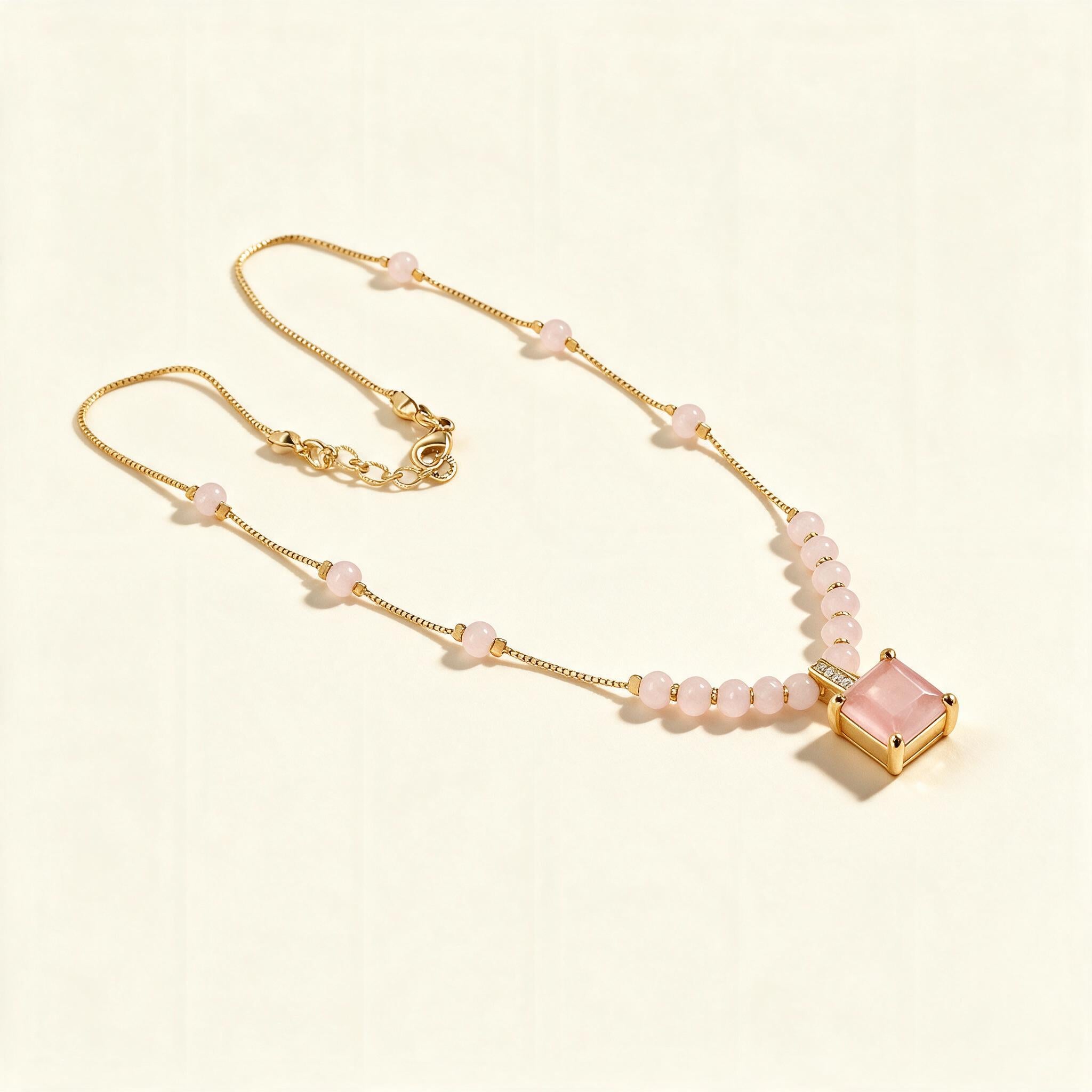 Gold-tone beaded chain necklace with rose pink square stone pendant