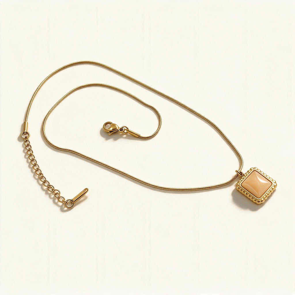Gold-tone snake chain necklace with champagne square cabochon pendant