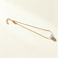 Gold-tone extra fine chain necklace with a single cream pearl