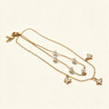 Gold-tone layered double chain necklace with pearls and butterfly charms