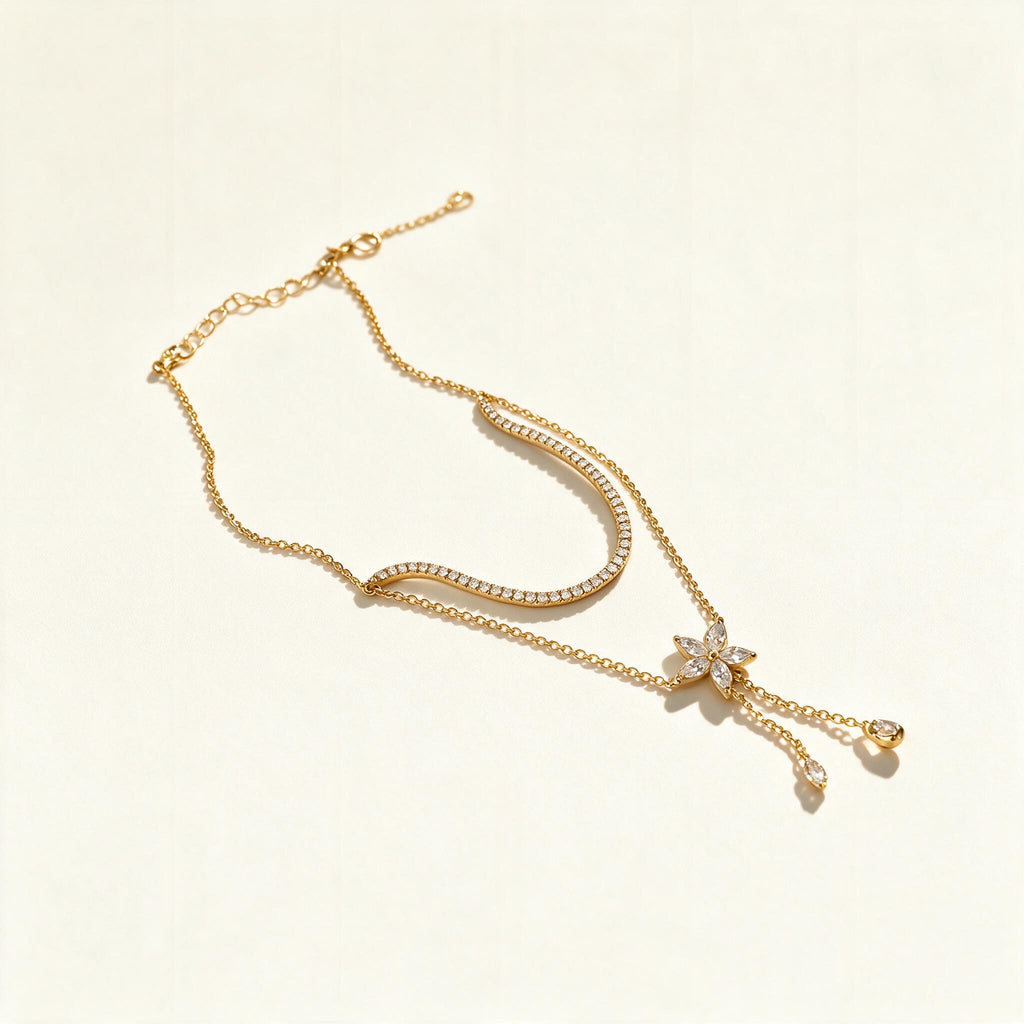 Gold-tone lariat necklace with pavé crystal arc, butterfly and hanging drops