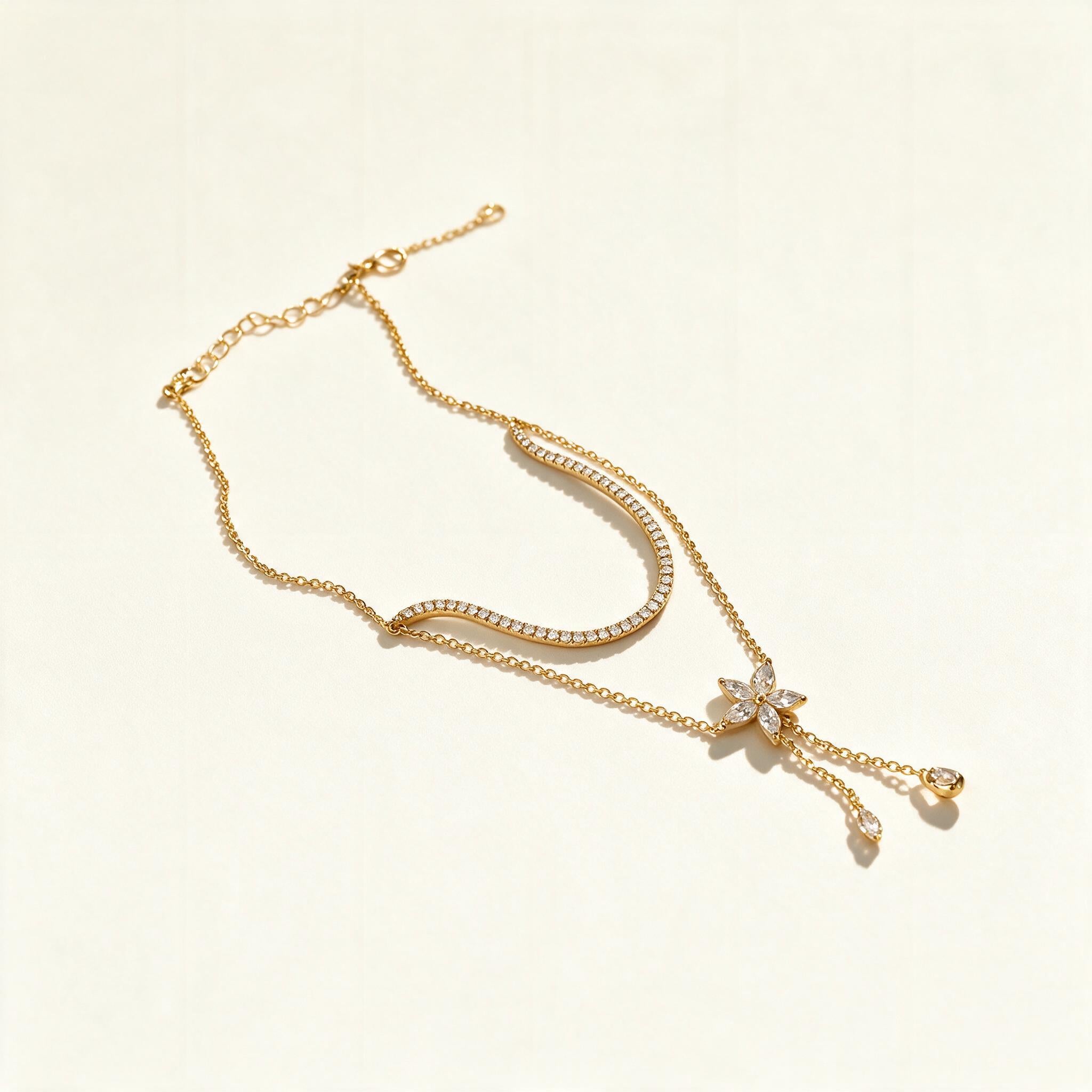 Gold-tone lariat necklace with pavé crystal arc, butterfly and hanging drops