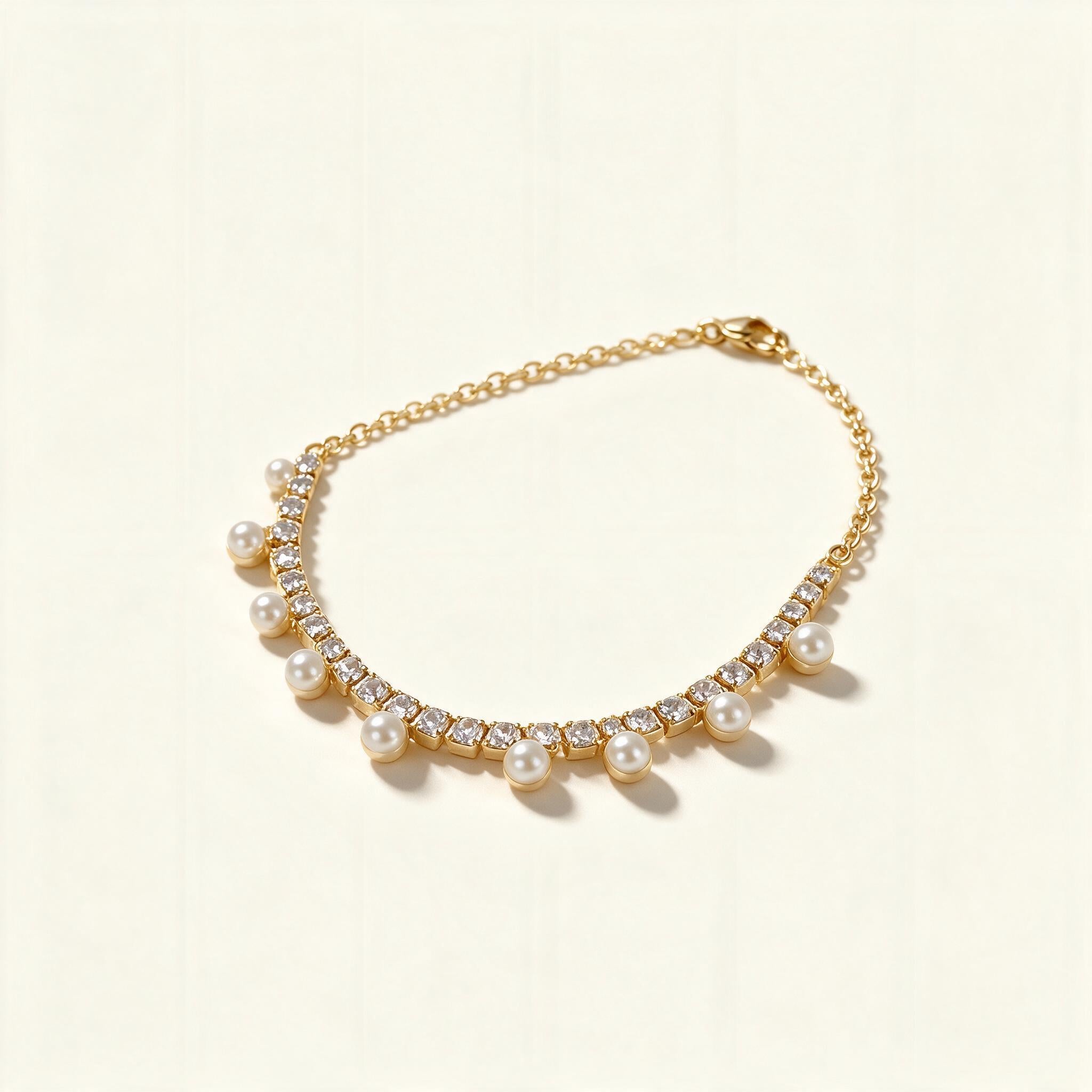 Gold-tone crystal tennis necklace with a fringe of small white shell pearls hanging below