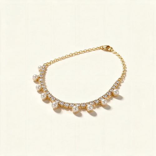 Gold-tone crystal tennis necklace with a fringe of small white shell pearls hanging below