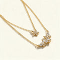 Gold-tone double layer necklace with marquise crystal butterfly trio and pave butterfly charm