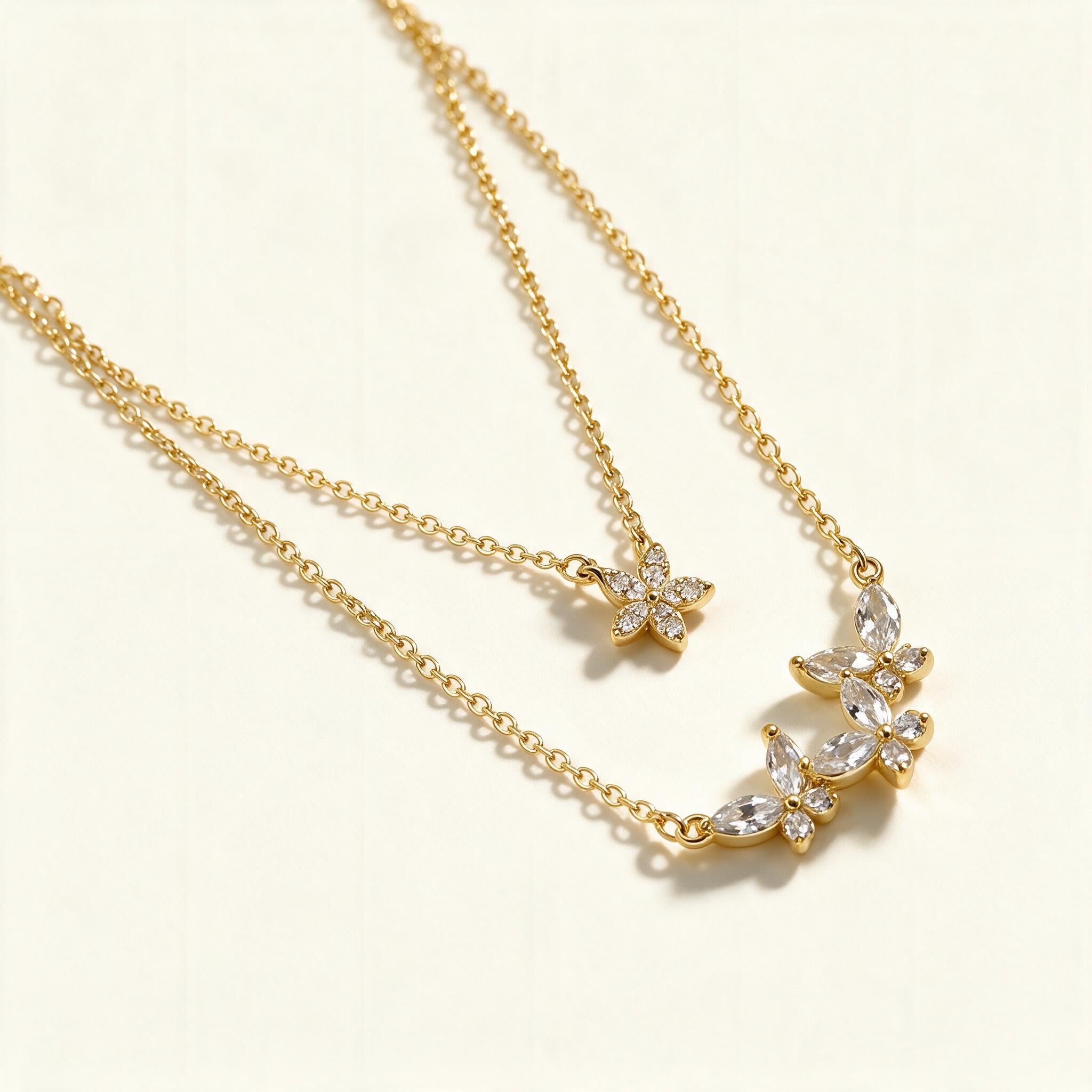 Gold-tone double layer necklace with marquise crystal butterfly trio and pave butterfly charm