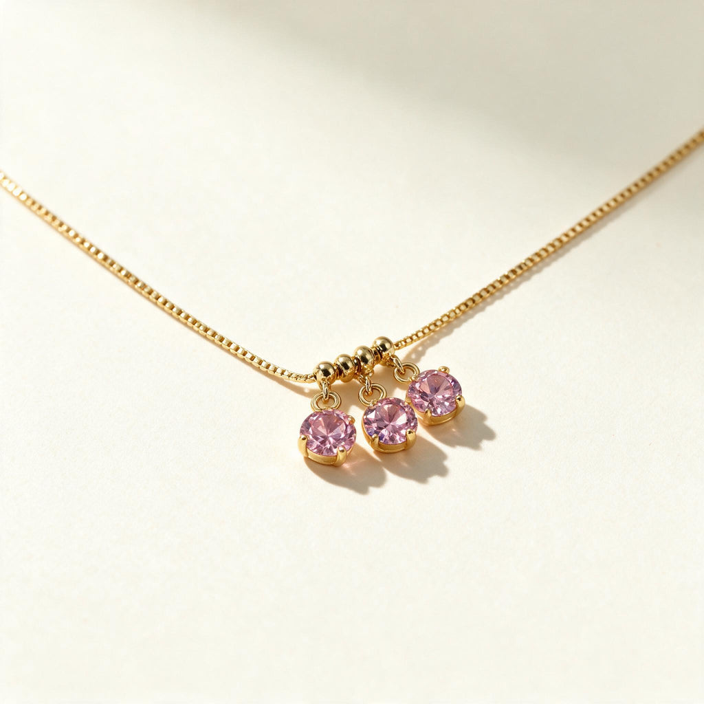 Gold-tone box chain necklace with three round pink cubic zirconia drop charms