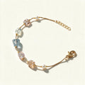 Gold-tone chain bracelet with pastel blue and pink crystal beads and small pearls