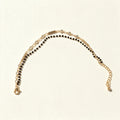 Gold-tone mangalsutra bracelet with black beads and clear cubic zirconia row