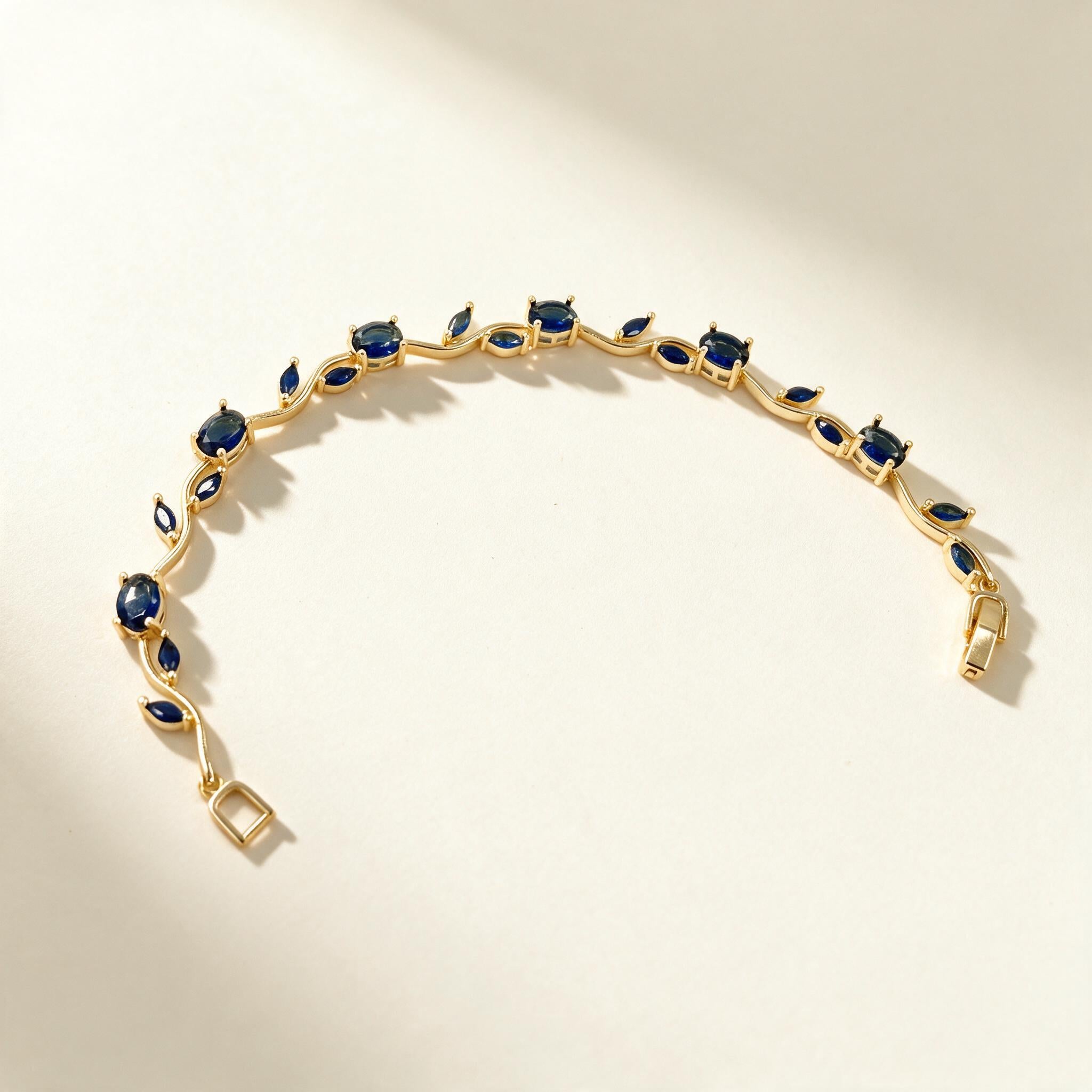 Gold-tone bracelet with large sapphire blue marquise and oval stones