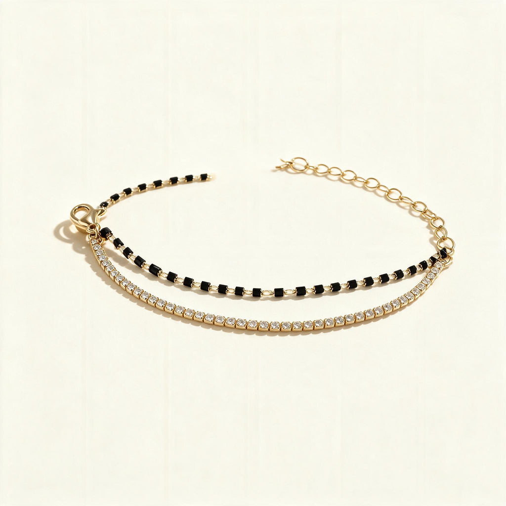 Gold-tone double row bracelet with black beads and clear cubic zirconia tennis line