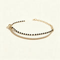 Gold-tone double row bracelet with black beads and clear cubic zirconia tennis line