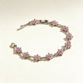 Silver-tone link bracelet with pink cubic zirconia flower stations