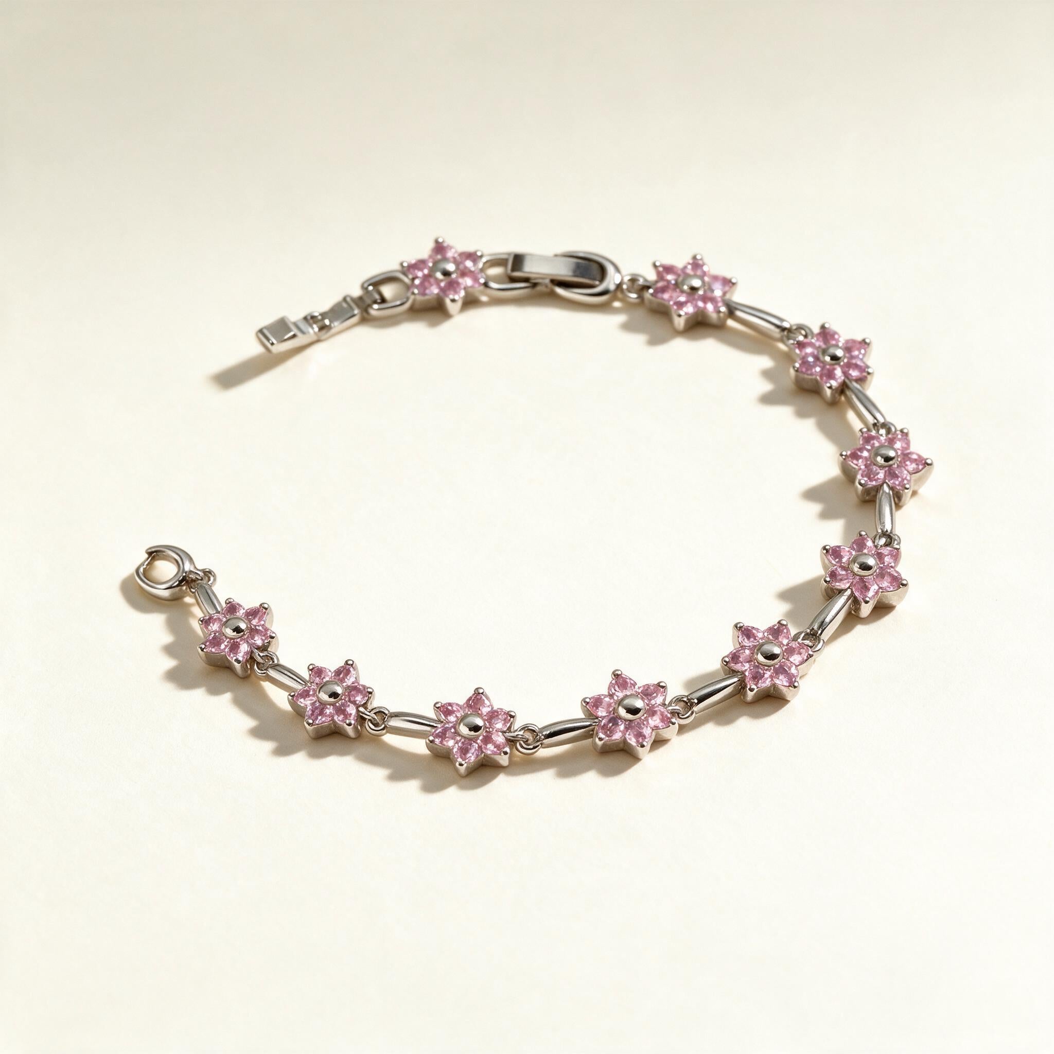 Silver-tone link bracelet with pink cubic zirconia flower stations