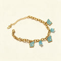 Gold-tone chunky oval link bracelet with turquoise enamel butterfly charms