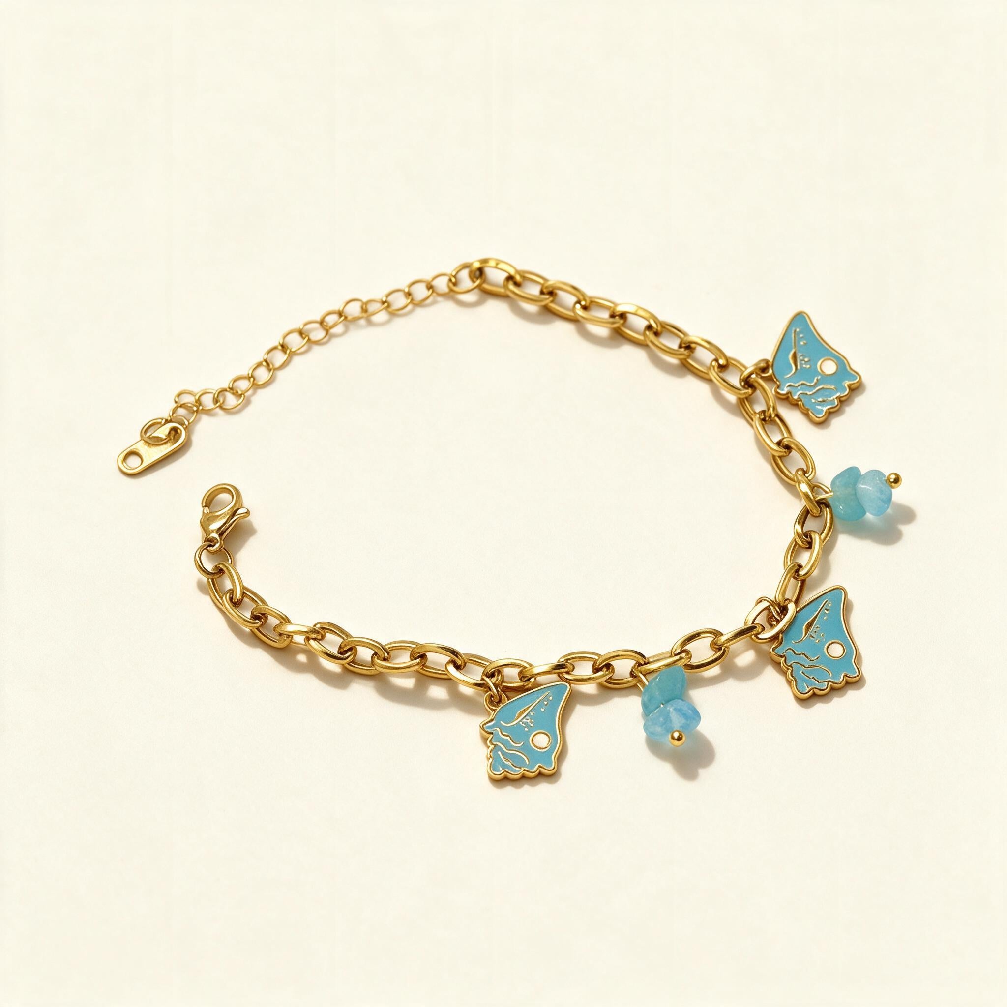 Gold-tone chunky oval link bracelet with turquoise enamel butterfly charms