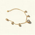 Gold-tone chain bracelet with graduated cubic zirconia bezel charms