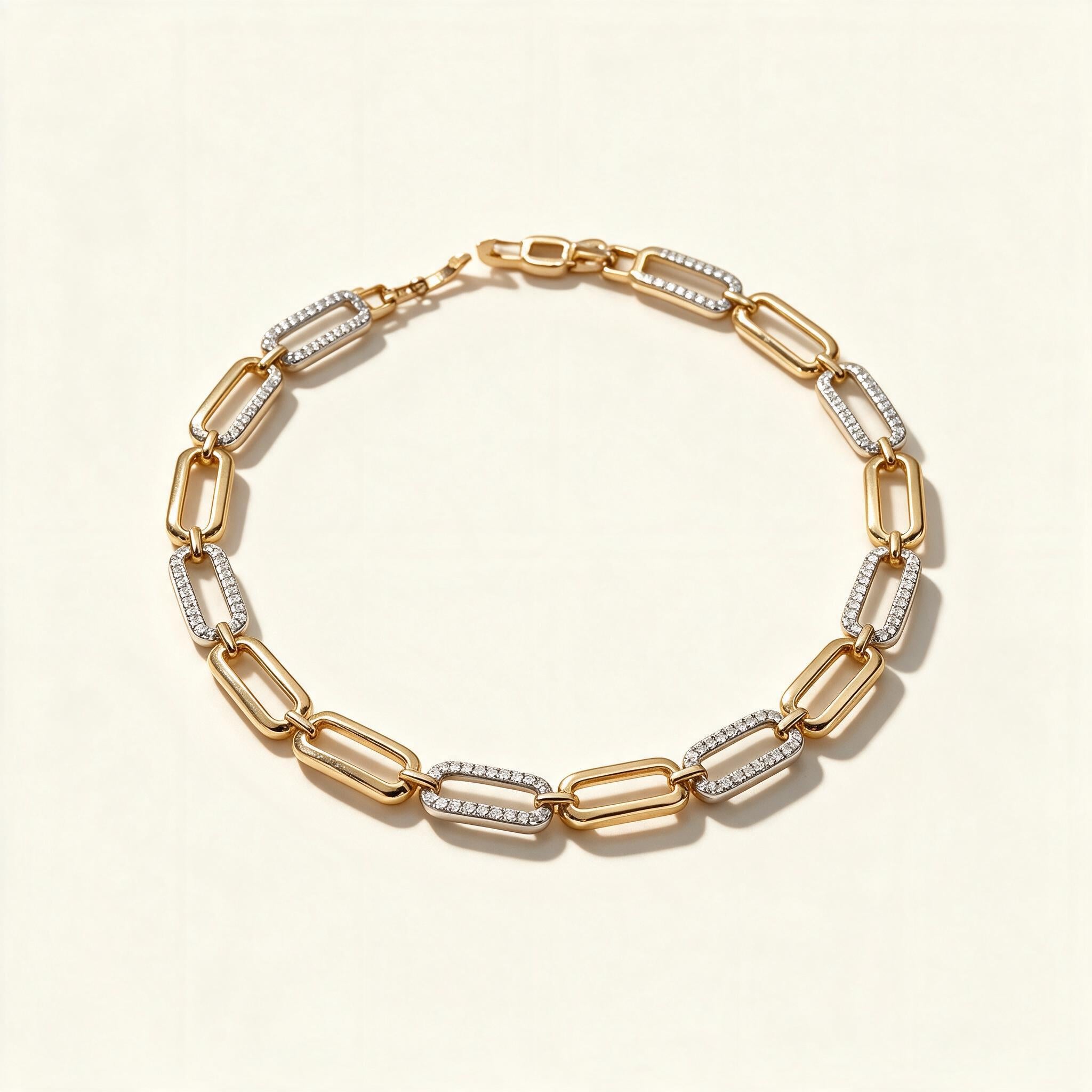 Gold-tone paperclip link bracelet with alternating pavé crystal links