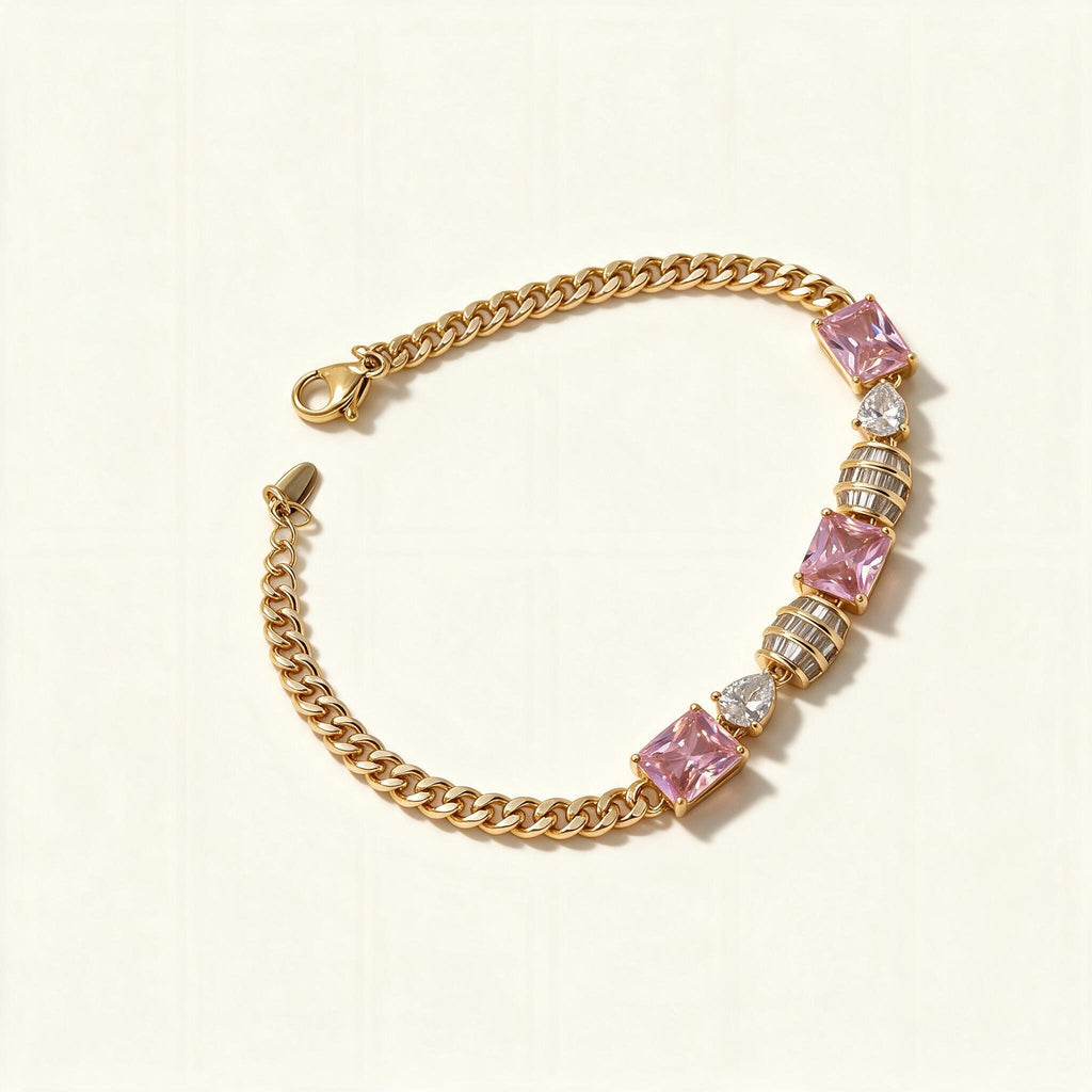 Gold-tone curb chain bracelet with emerald-cut pink stones and clear heart stones