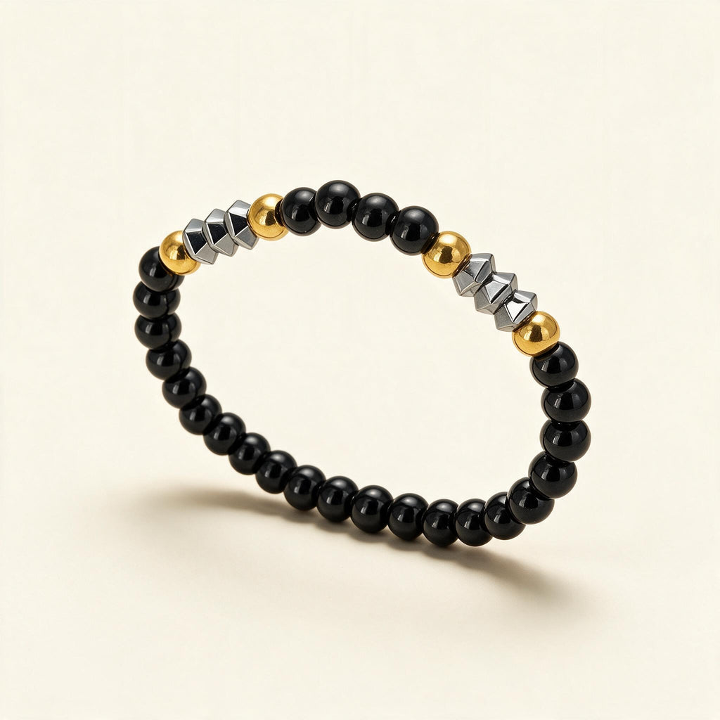 Black bead stretch bracelet with gold ball beads and faceted silver-tone barrel beads