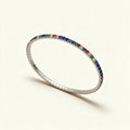 Silver-tone thin stretch tennis bracelet set with blue, red, green and champagne crystals