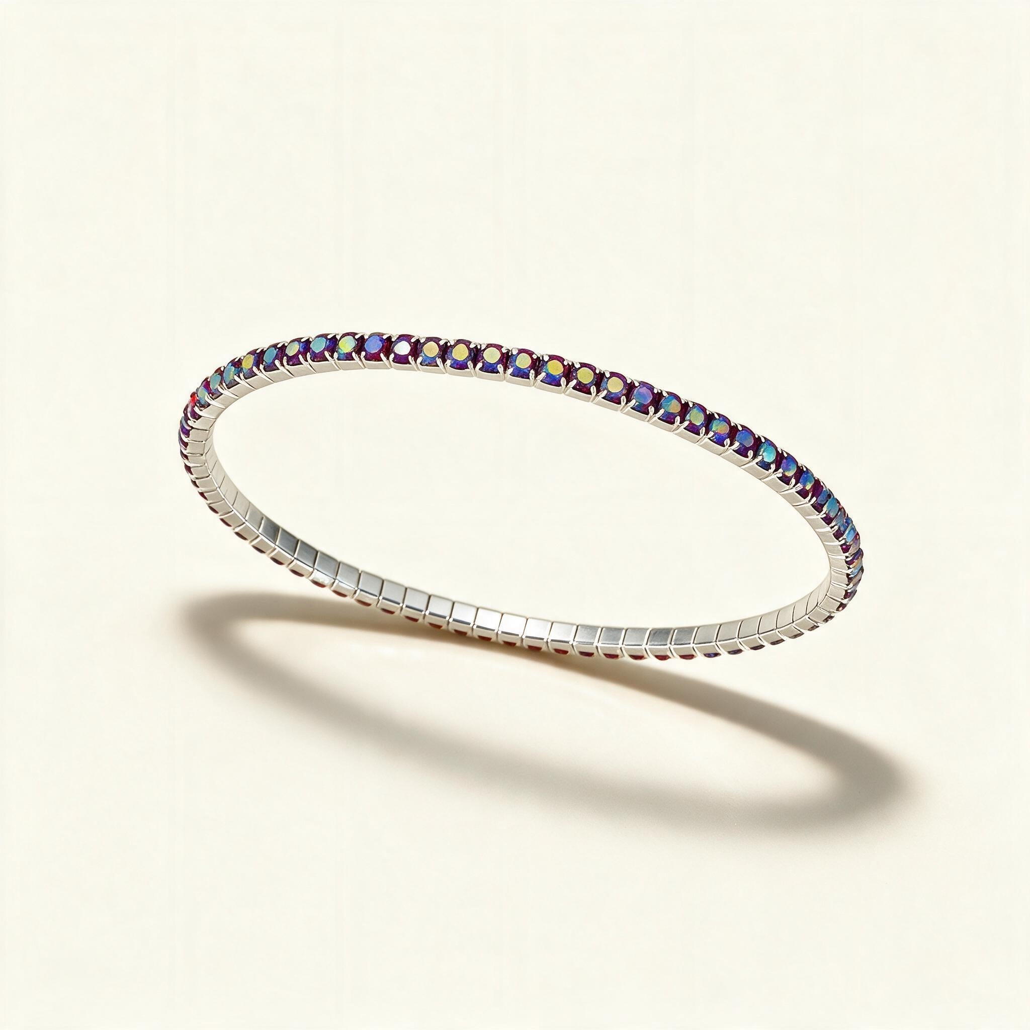 Silver-tone thin stretch tennis bracelet set with a row of iridescent pink and purple crystals