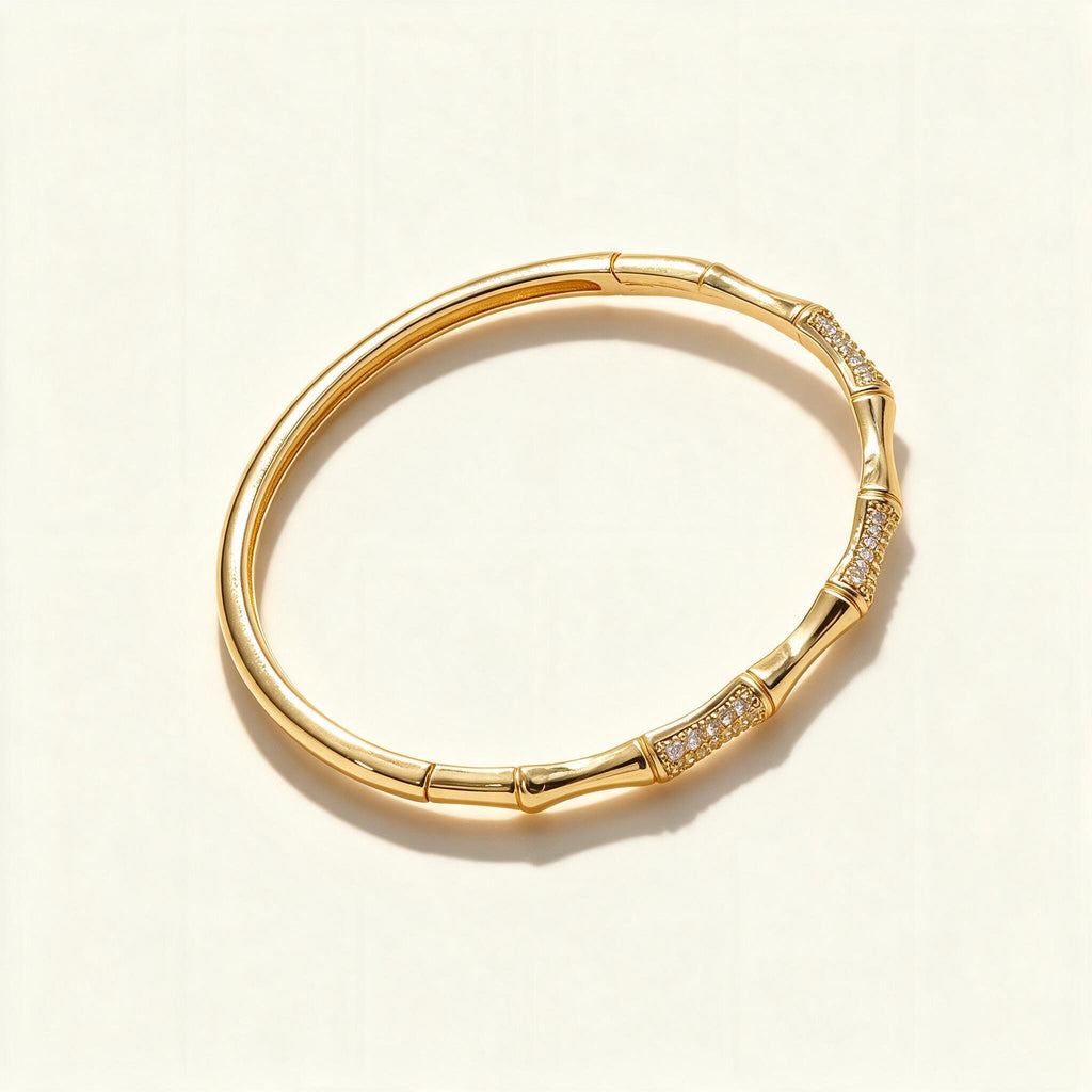 Gold-tone bamboo segment bangle with pavé cubic zirconia sections
