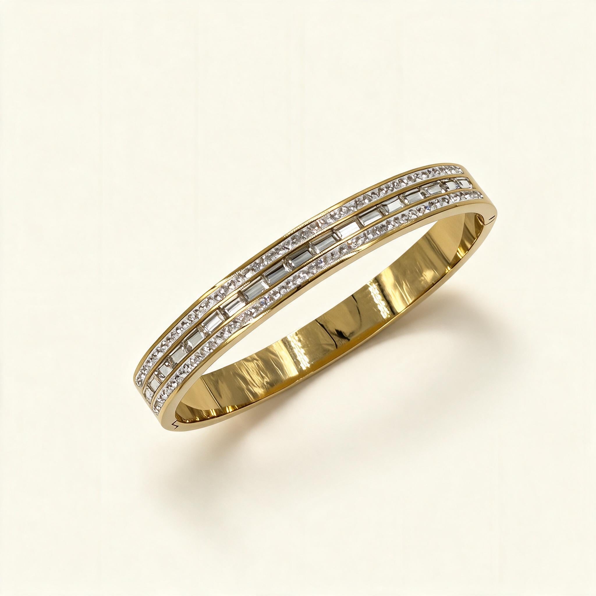 Wide gold-tone bangle with baguette cubic zirconia channel and pavé edges