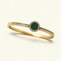 Gold-tone bangle with green malachite disc in crystal halo and baguette channel band