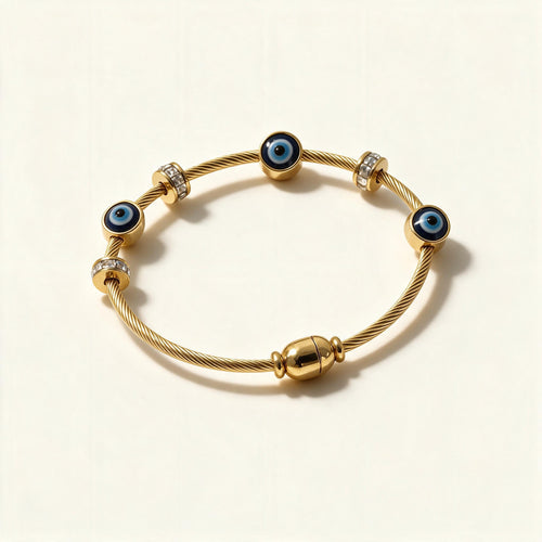 Gold-tone twisted cable bangle with blue evil eye beads and pavé rondelles