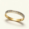 Two-tone gold and silver bangle with cut-out clover lattice and clear cubic zirconia