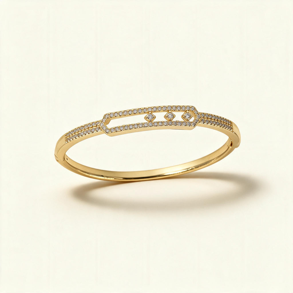 Gold-tone pave bangle with an open frame holding three floating clear crystals