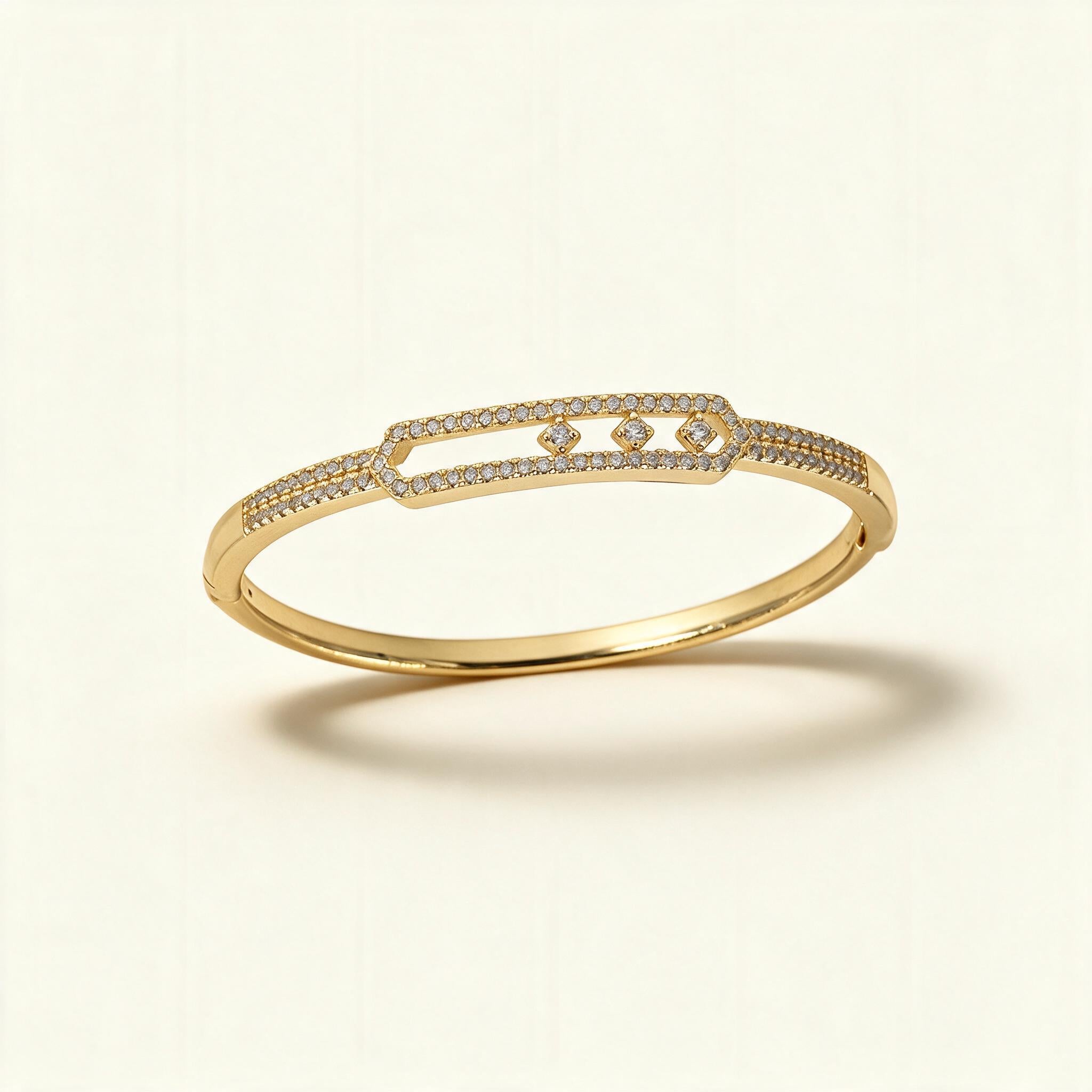 Gold-tone pave bangle with an open frame holding three floating clear crystals