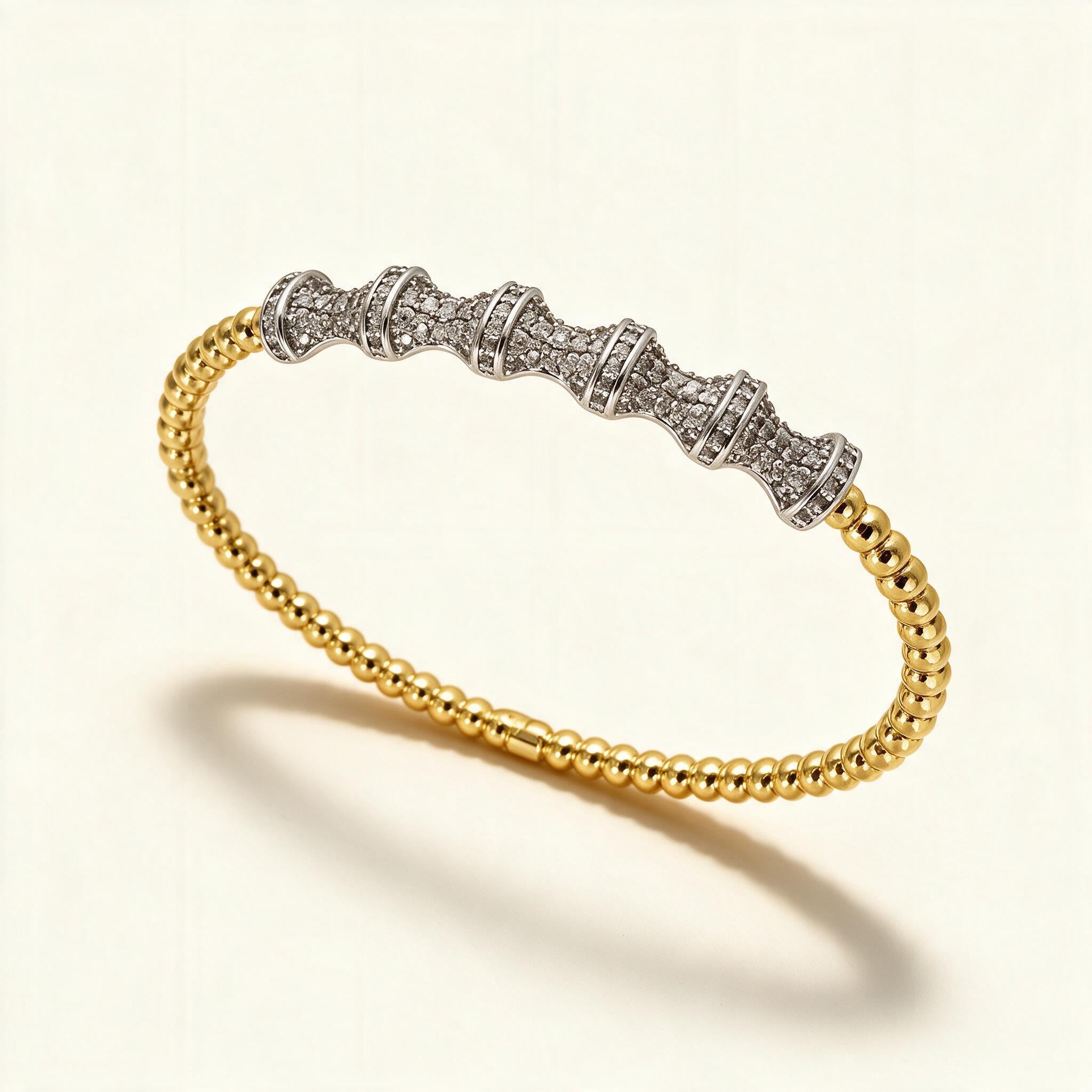 Gold beaded flexible bangle with a silver-tone pave crystal bar across the top