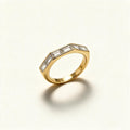 Gold-tone angular band ring with six flush-set baguette cut crystals across the top