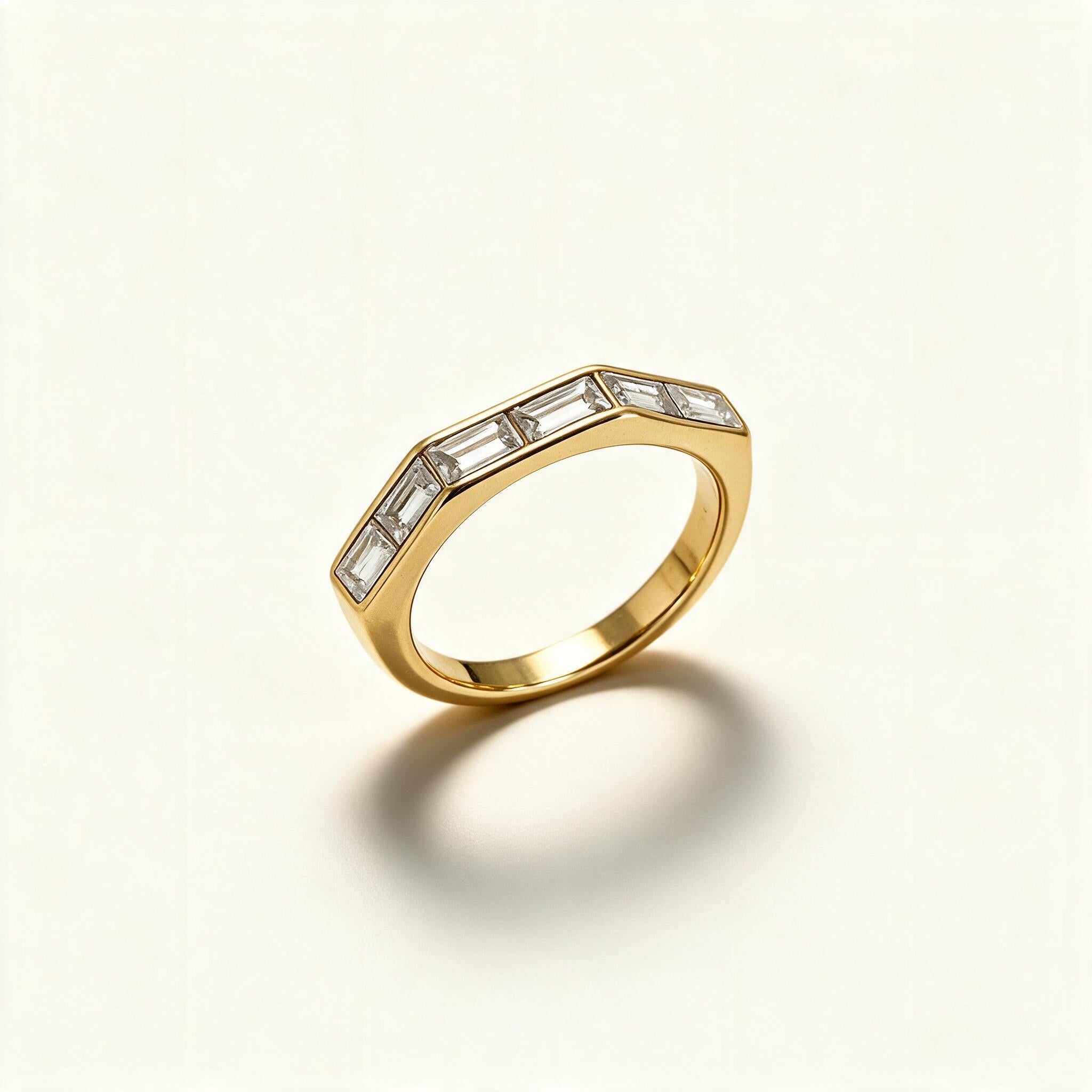 Gold-tone angular band ring with six flush-set baguette cut crystals across the top