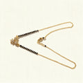 Thin gold-tone mangalsutra with black beads and small cubic zirconia star