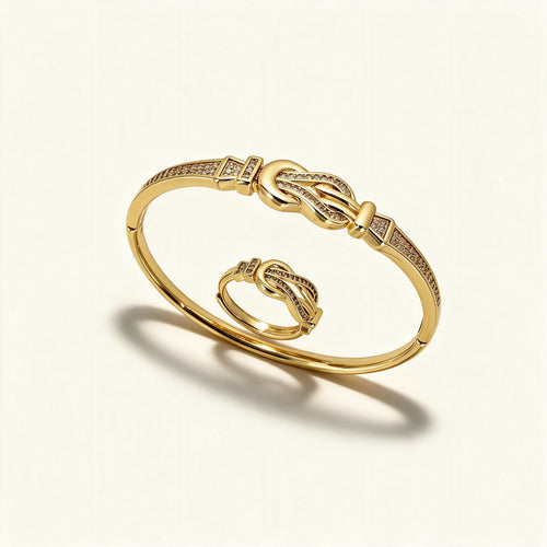 Gold-tone bangle and matching ring with interlocking knot motif set with clear crystals