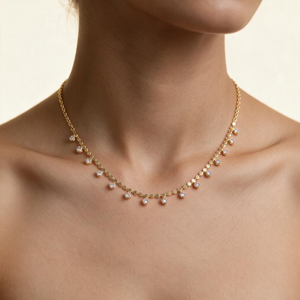 Woman wearing the gold-tone cubic zirconia drop chain necklace at the collarbone