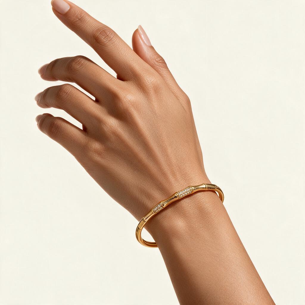 Woman wearing the Wilde gold tone bamboo segment pave bangle on her wrist