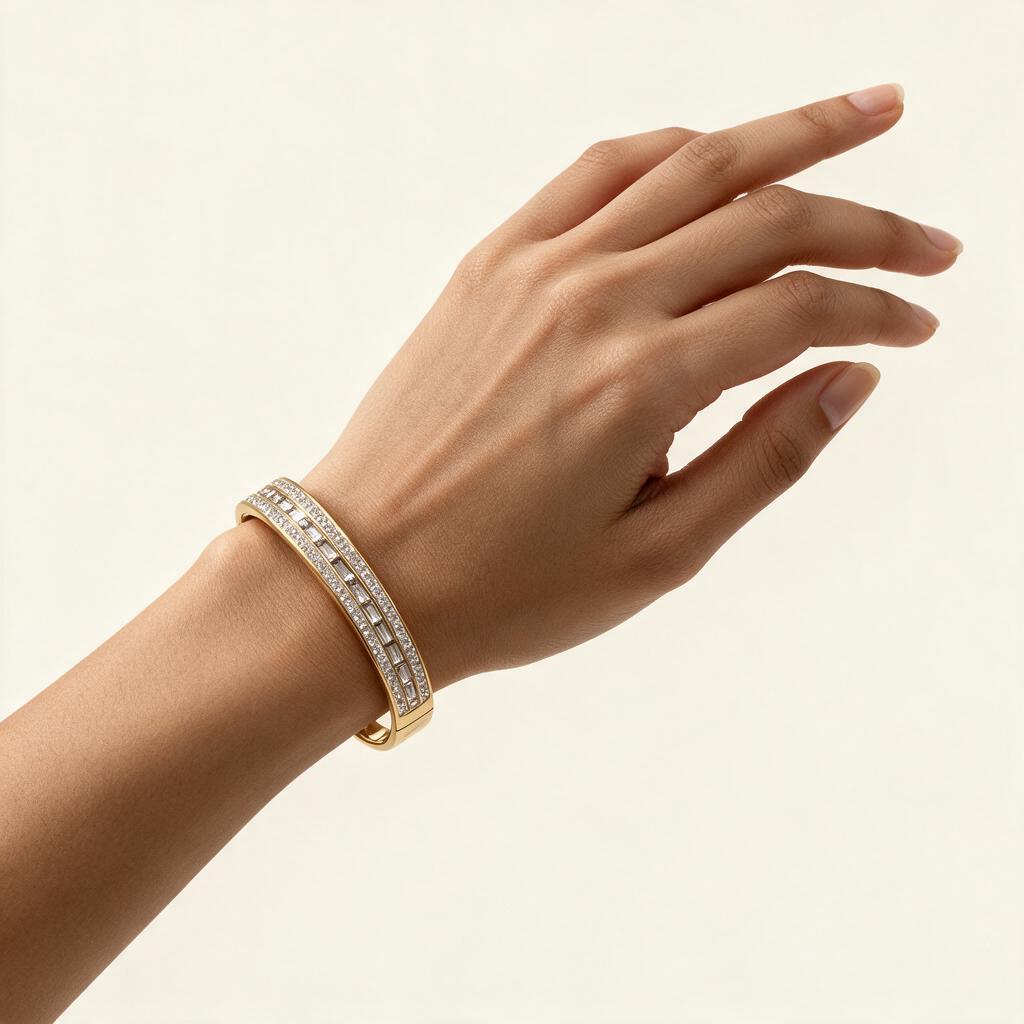 Woman wearing the Monarch gold tone baguette channel wide bangle on her wrist